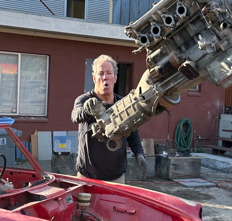 Matthew guiding an engine tear down on a vintage Alfa Romeo Spider
