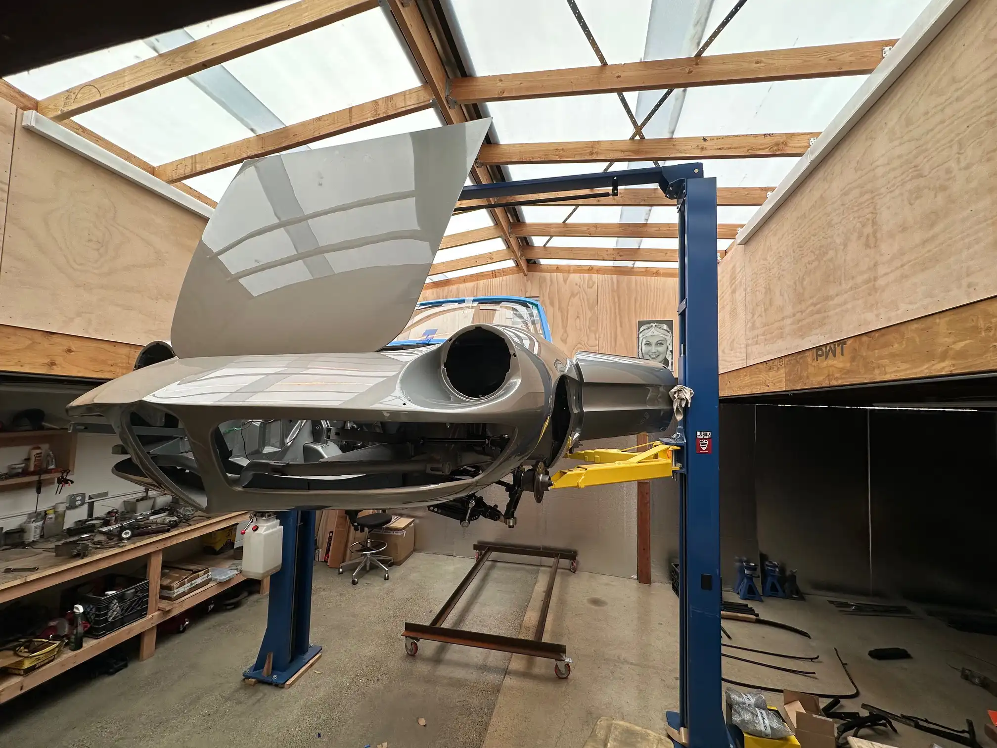 Alfa Romeo Spider Odette car lift front left doors hood open painted elevated