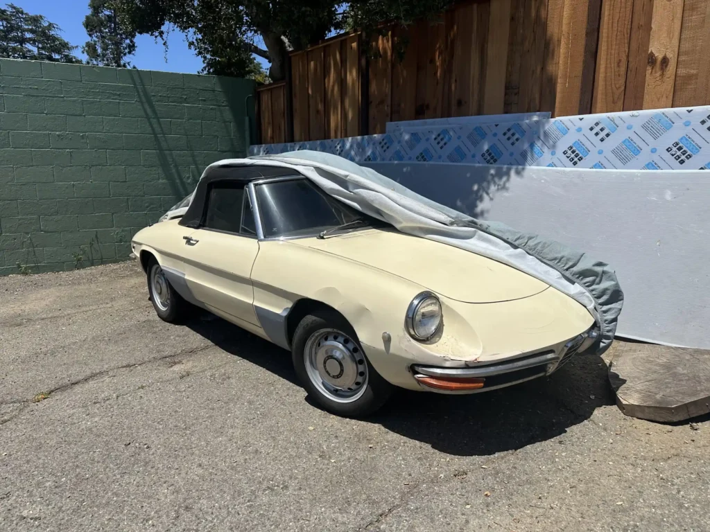 vintage yellow Alfa Romeo Spider Duetto with its top up